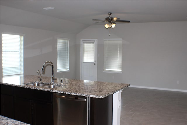 kitchen featuring baseboards, dishwasher, a ceiling fan, light stone countertops, and a sink