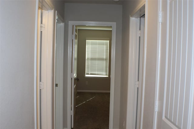 corridor featuring carpet and baseboards