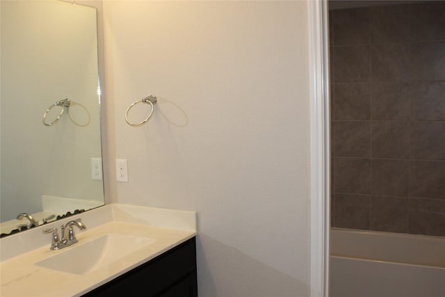 bathroom featuring a tub to relax in, walk in shower, and vanity