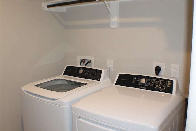 clothes washing area featuring washer and dryer