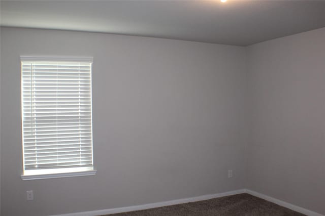 carpeted spare room with baseboards