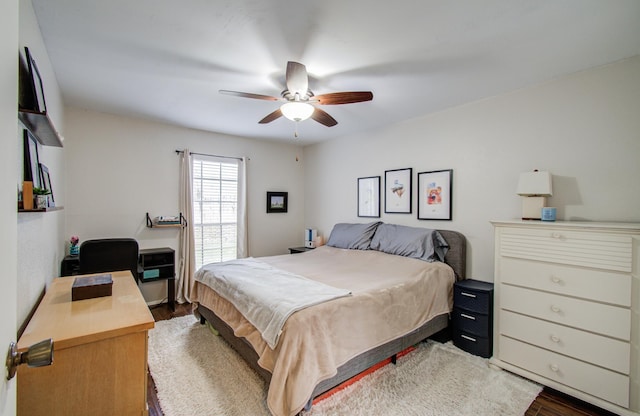 bedroom featuring a ceiling fan and dark wood-style flooring