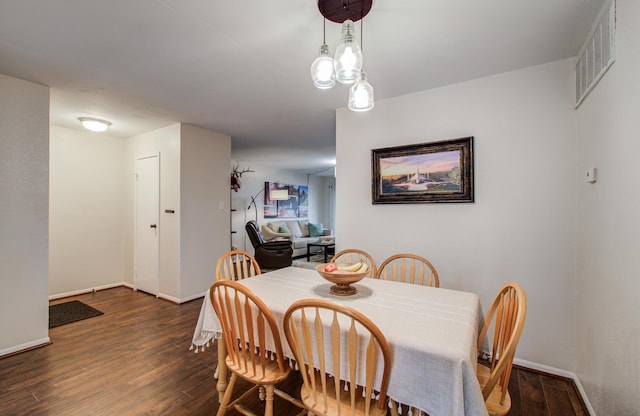 dining space with visible vents, baseboards, and wood finished floors