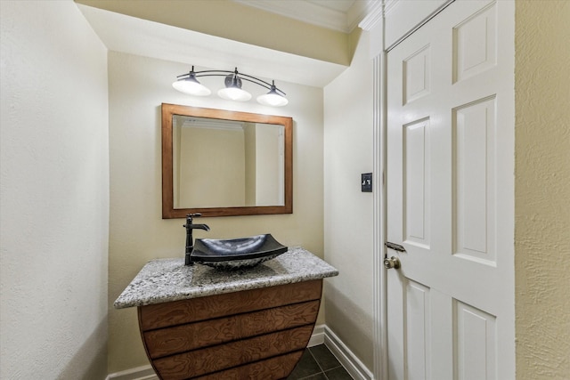 bathroom with tile patterned flooring, vanity, and baseboards