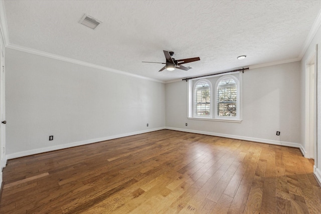 spare room with visible vents, ornamental molding, ceiling fan, and hardwood / wood-style flooring