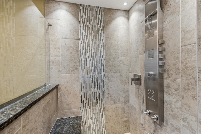 bathroom with a tile shower