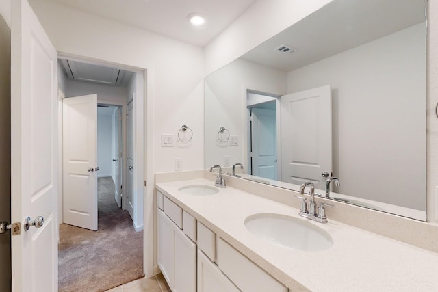 bathroom with double vanity, visible vents, and a sink