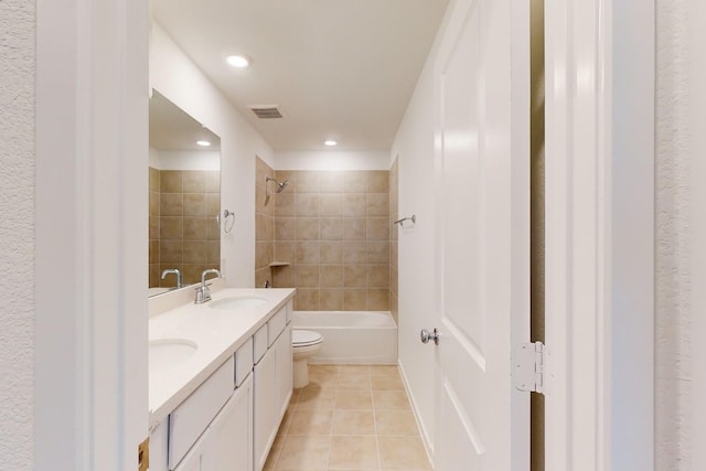 full bath with double vanity, toilet, tile patterned floors, shower / washtub combination, and a sink