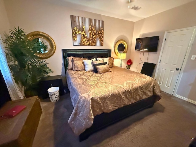 carpeted bedroom featuring visible vents