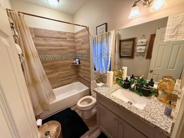 bathroom featuring vanity, shower / bath combo with shower curtain, and toilet