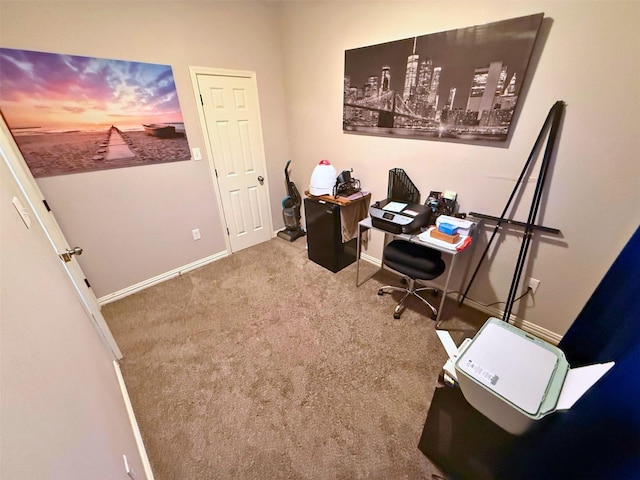 carpeted office space featuring baseboards