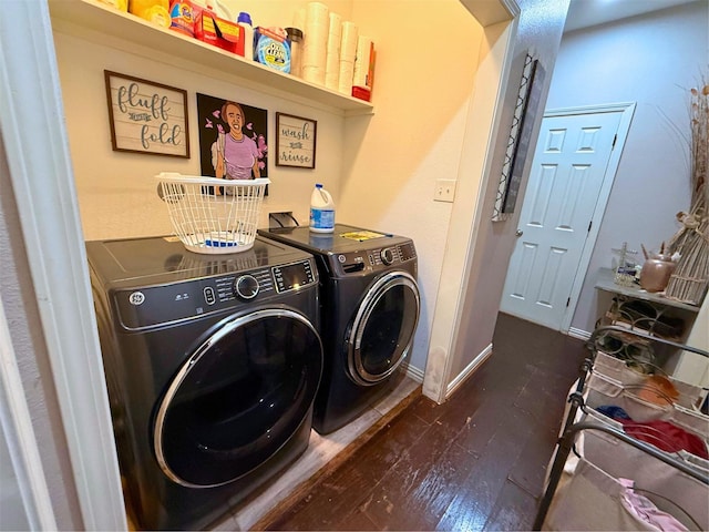 laundry room with washing machine and dryer, laundry area, baseboards, and dark wood-style flooring