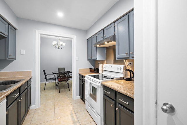 kitchen featuring light tile patterned floors, under cabinet range hood, white appliances, a sink, and baseboards