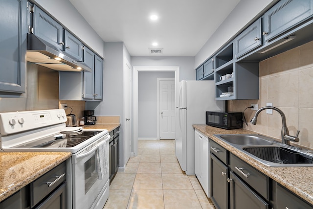 kitchen featuring light tile patterned floors, backsplash, a sink, white appliances, and under cabinet range hood