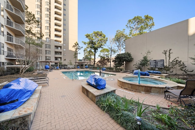 pool featuring a patio area and a jacuzzi