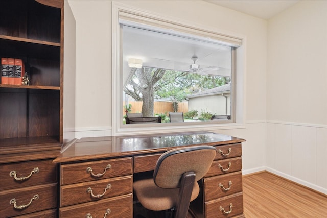 office featuring light wood-style floors and wainscoting