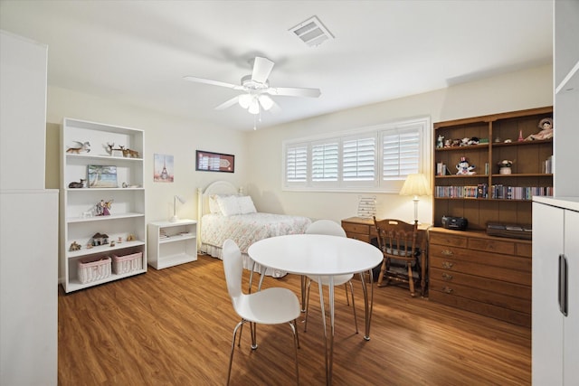 bedroom with wood finished floors, visible vents, and a ceiling fan