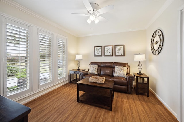 living room with baseboards, crown molding, and wood finished floors