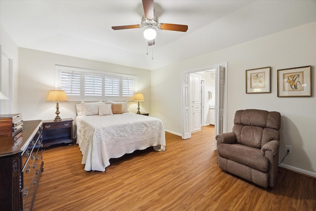 bedroom with ceiling fan, baseboards, and wood finished floors