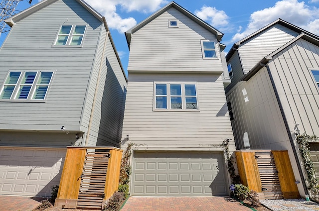 view of front of home with decorative driveway and an attached garage