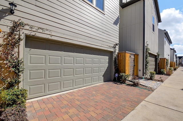 garage featuring decorative driveway