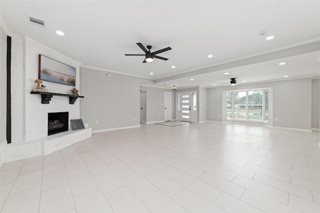 unfurnished living room with a large fireplace, visible vents, crown molding, and baseboards