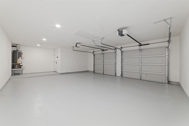 garage with water heater, recessed lighting, and a garage door opener