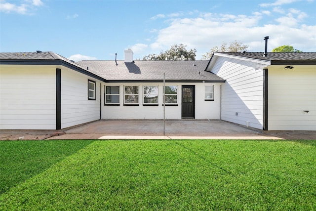 back of property featuring a patio area, a shingled roof, a chimney, and a lawn