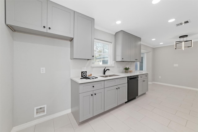 kitchen featuring visible vents, dishwasher, gray cabinets, light countertops, and a sink