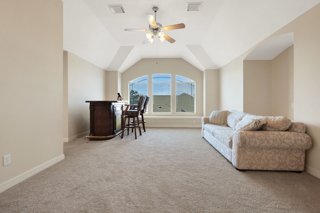 carpeted home office featuring a ceiling fan, lofted ceiling, visible vents, and baseboards