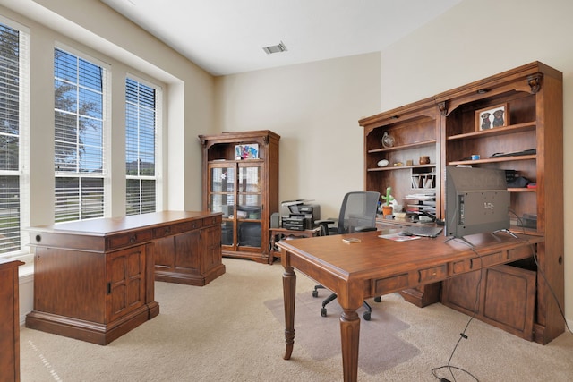 office with light colored carpet, a wealth of natural light, and visible vents