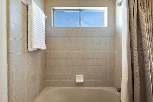 bathroom featuring shower / bath combination with curtain and a wealth of natural light