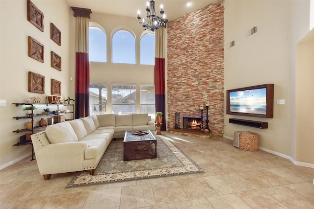 living area featuring a wealth of natural light, a fireplace, visible vents, and baseboards