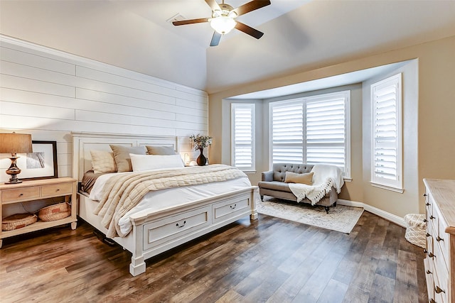 bedroom with a ceiling fan, vaulted ceiling, dark wood finished floors, and baseboards