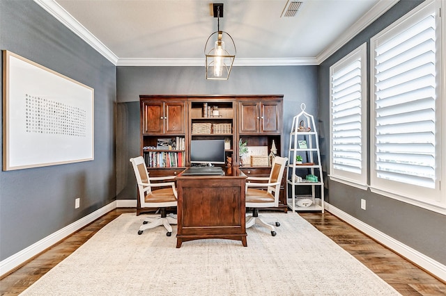 office featuring a healthy amount of sunlight, baseboards, and wood finished floors