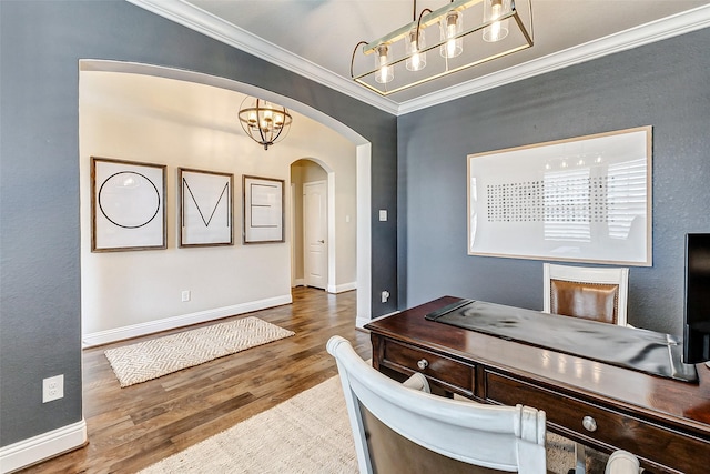 office space featuring arched walkways, a chandelier, wood finished floors, baseboards, and ornamental molding