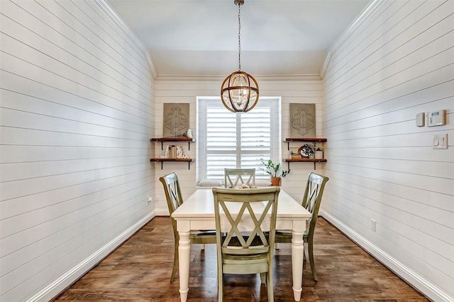 dining space featuring dark wood-style flooring, crown molding, and baseboards