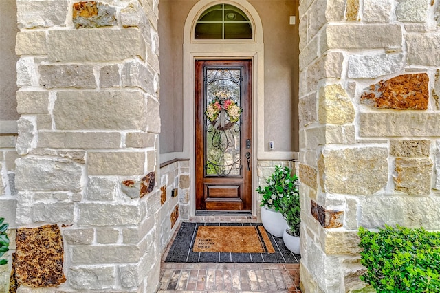 view of exterior entry featuring stone siding