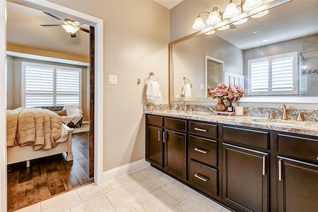 ensuite bathroom with double vanity, a sink, ensuite bath, and tile patterned floors