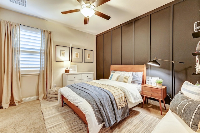 bedroom featuring baseboards, ceiling fan, visible vents, and light colored carpet