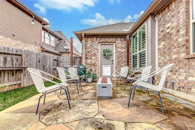 view of patio with fence and a fire pit