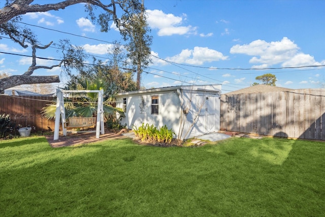 view of yard with fence and an outdoor structure