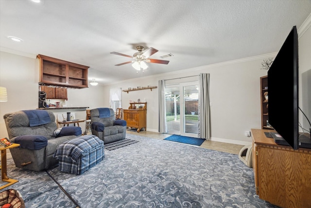 living area featuring a textured ceiling, a ceiling fan, baseboards, visible vents, and crown molding