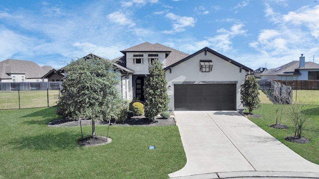 view of front of property featuring driveway, an attached garage, fence, and a front yard