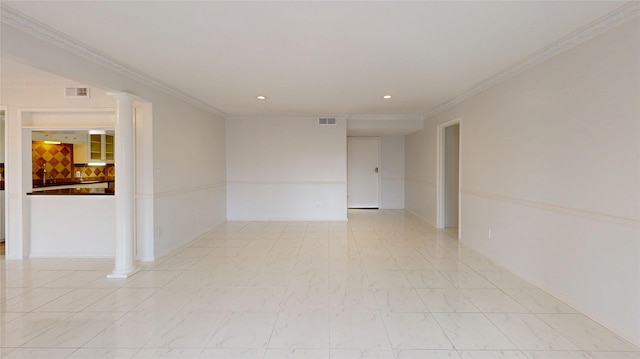 spare room featuring ornamental molding, visible vents, and ornate columns