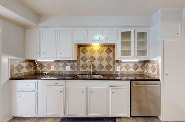 kitchen featuring a sink, white cabinetry, glass insert cabinets, and dishwasher