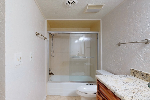 bathroom with a textured ceiling, a textured wall, toilet, bath / shower combo with glass door, and visible vents