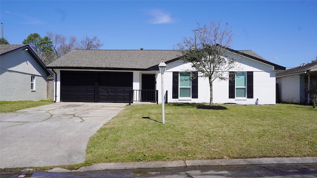 ranch-style home with driveway, roof with shingles, an attached garage, a front lawn, and brick siding