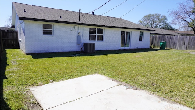 back of property featuring central air condition unit, a fenced backyard, and brick siding