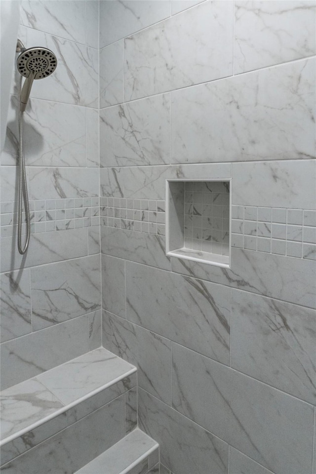 bathroom with tiled shower